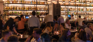 A busy bar, crowded with patrons.