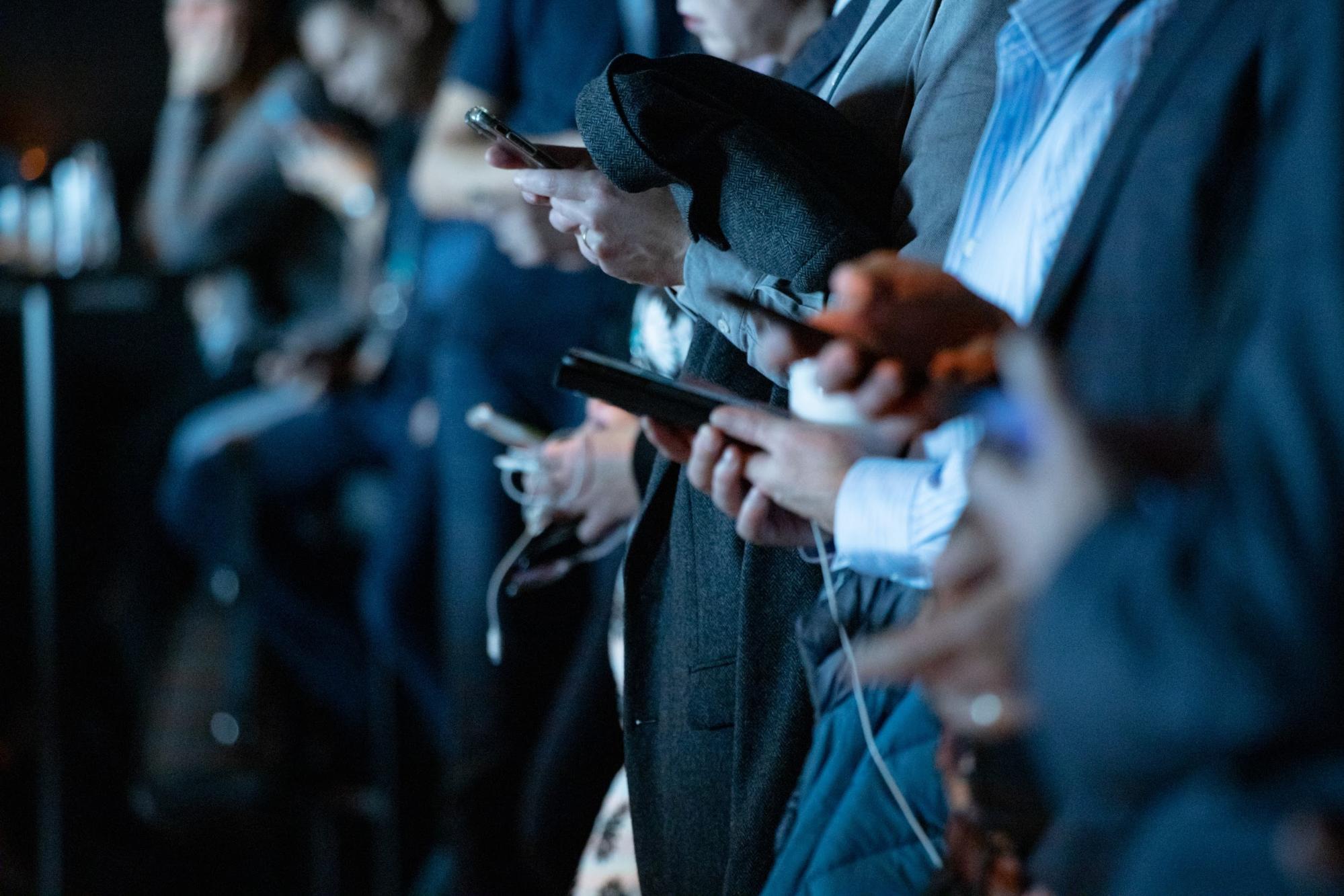 Several individuals using smartphones