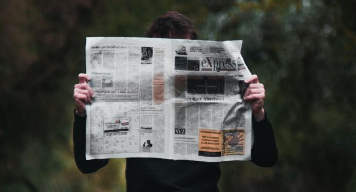 Man holding newspaper
