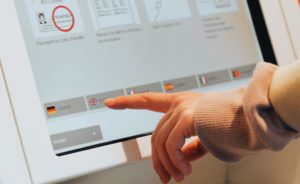 A user interacting with a touchscreen displays