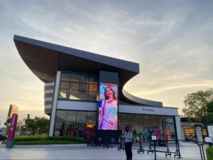 A large building with a digital display at the front 