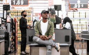 A shopper sitting by a supermarket check out